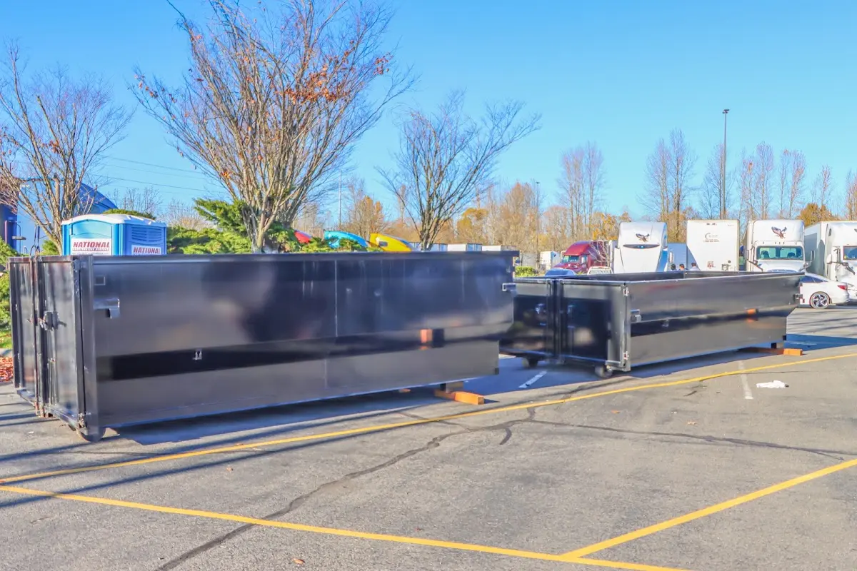 Professional dumpster rental service with roll-off container on residential driveway in Jersey Village